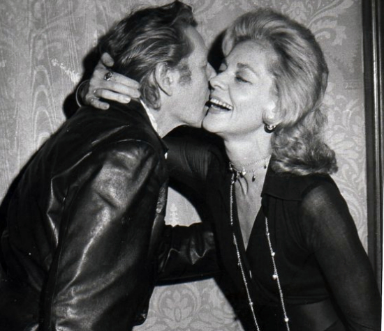 Danny Kaye came from his Broadway show Two By Two to congratulate Lauren Bacall on the first anniversary of her Broadway musical Applause at a party in 1971, at the Americana Hotel in New York. Photo by Tim Boxer