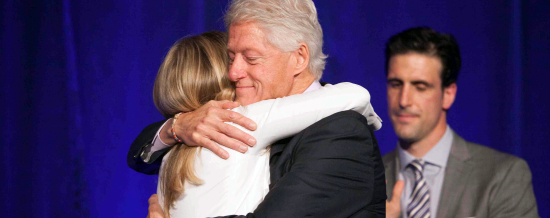 Chelsea Clinton presents surprises her father, the former president of the U.S.