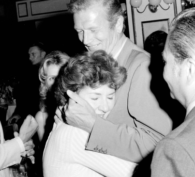 John Lindsay hugging Maureen Stapleton at Raffles Club in the Sherry Netherland Hotel, following preview of Something for Everyone, the first film that Broadway producer Hal Prince produced and directed