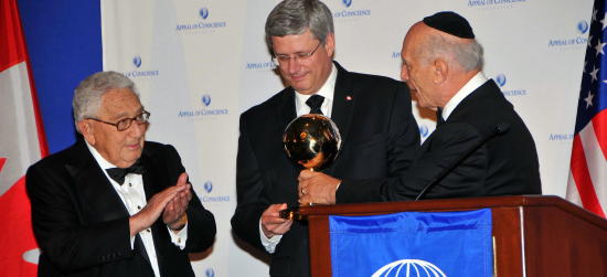 Prime Minister Stephen Harper accepts Appeal of Conscience Foundation’s World Statesman Award from founder/president Rabbi Arthur Schneier with Henry Kissinger’s hearty approval.