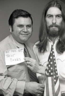 Pete Bennett and George Harrison with flag and message, May 1, 1970