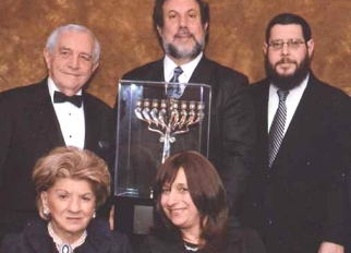 Jean Gluck and guest of honor Chani Rosenzveig (seated), with Eugen Gluck and guest of honor Rabbi Ely Rosenzveig