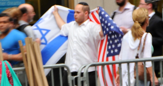 Counter-demonstrator carries a message of America-Israel solidarity to the anti-Zionist protesters