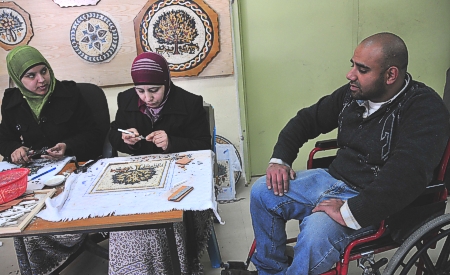 Handicapped artisans making mosaics