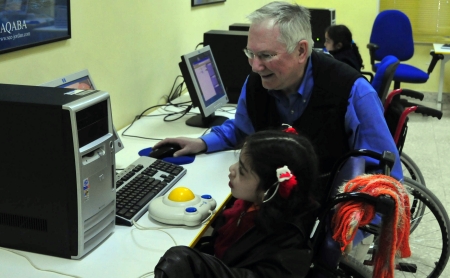 Tim helps young girl with computer